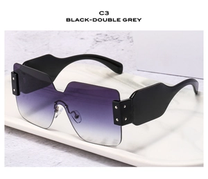 Side view of oversized frameless sunglasses with black temples and purple gradient lenses
