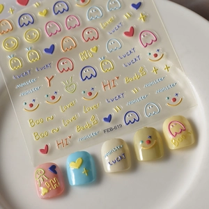 Macro shot of 3D embossed nail stickers featuring colorful monsters and hearts on tips