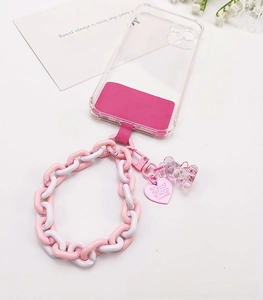 Detail of pink resin chain with crystal bear charm and heart pendant on phone case