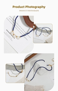 Detail of blue stone beaded necklace featuring three white pearls and a gold lobster clasp