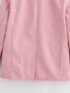 Detailed back view of a pink blazer featuring a clean single vent slit and fine stitching
