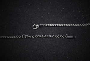 Macro shot of silver stainless steel flat link chain with lobster clasp and extension