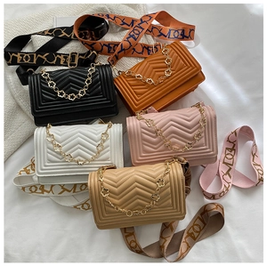 Detailed display of five quilted leather handbags in various colors with golden chain straps
