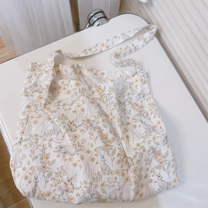 Close-up of floral rabbit print on cotton canvas tote bag with soft lifestyle lighting