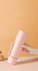 Detail of pink vacuum flask showing 360-degree leak-proof seal and portable handle