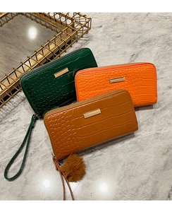 Three crocodile pattern long wallets in green, orange and brown with gold zippers
