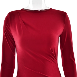 Detail of red long sleeve dress featuring asymmetric ruching and a slim fit design