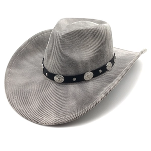 Detail of vintage cowboy hat featuring black leather band and silver metal studs