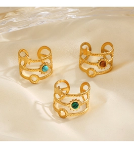Detailed view of three gold stainless steel rings with colorful natural stone inlays