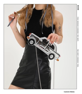Silver car-shaped crossbody bag with checkered pattern and long metal ball chain
