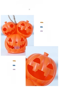 Detail of stacked Halloween pumpkins with hollow smiling faces and rustic rope handle