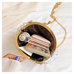 Top view of sequin crossbody bag with gold frame showing internal storage space