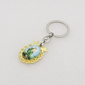 Macro detail of golden Saint Jude religious keychain with crown and rope texture frame