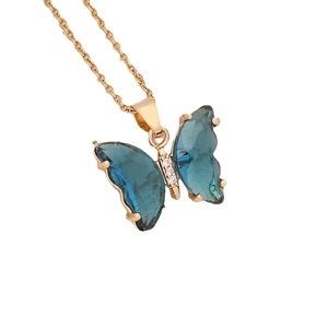 Elegant gold butterfly necklace with teal blue crystal pendant on slim cross chain