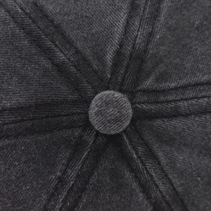 Macro shot of mountain peak baseball cap top showing washed twill texture and stitching