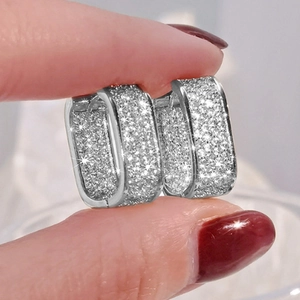 Macro view of silver rectangular hoop earrings with micro-paved cubic zirconia stones