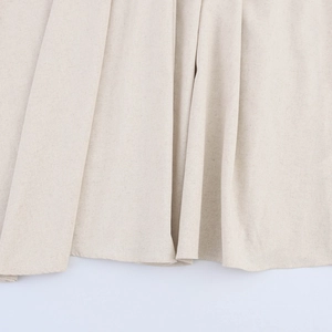 Jupe longue évasée en lin beige au style minimaliste avec texture tissée et beau drapé