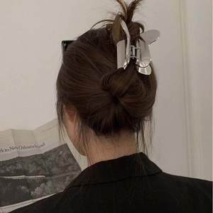 Close-up of a large silver butterfly hair claw clip for elegant women styling