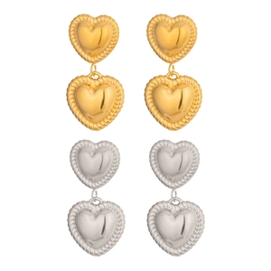 Classic gold and silver heart drop earrings with textured rope edges on white background