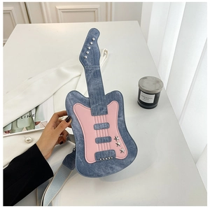 Detail of guitar-shaped denim crossbody bag with star studs and pink patchwork