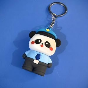 Detail shot of cute silicone panda police keychain with blue uniform and metal ring
