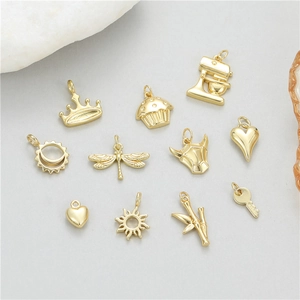Set of 12 gold-plated 14K charms including crown, heart, and sun for jewelry making