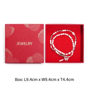 Detailed view of square red jewelry gift box measuring 9.4cm with interior display