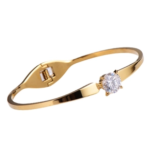 Classic gold titanium steel bracelet featuring a brilliant round white crystal centerpiece