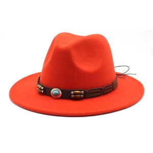 Macro shot of red wide-brim felt hat featuring a leather band with turquoise stone