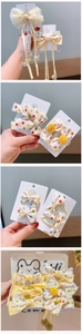 Detailed set of colorful polka dot bow hair clips with lace ribbons in a storage box