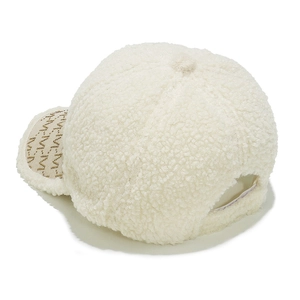 Detailed close-up of off-white sherpa baseball cap with gold M letter embroidery