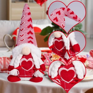 Close-up of pink knitted gnome hat with red hearts and white braided pigtails decor