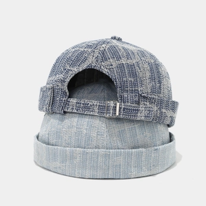 Close-up of vintage denim docker caps in blue and grey with adjustable metal buckle