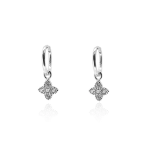 Close-up of silver star earrings with pave-set zircon stones on white background