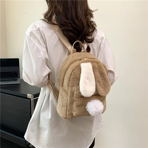 Cute brown plush rabbit backpack with white ears and pom-pom tail shown on a model