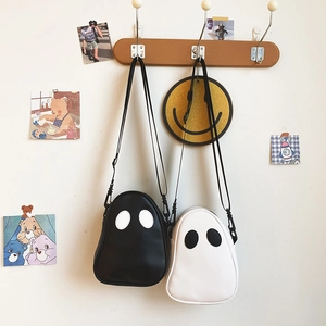 Close-up of ghost-shaped PU crossbody bags in black and white with cute eye detail
