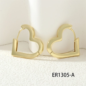 Detailed view of gold hollow heart-shaped hoop earrings on white textured props