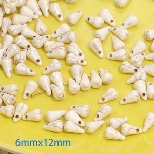 Macro detail of 6x12mm white marble texture teardrop stone beads for jewelry making