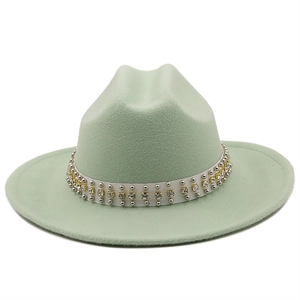 Detail view of mint green wool fedora hat with silver studs and rhinestone hat band