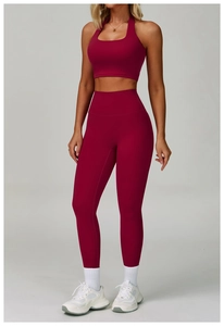 Front view of women's dark red yoga set featuring halter neck top and high-waist leggings