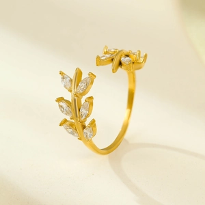French style 18K gold plated leaf ring with sparkling zircons on textured warm background