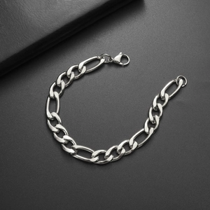 Macro shot of silver Figaro chain links and lobster clasp on black background