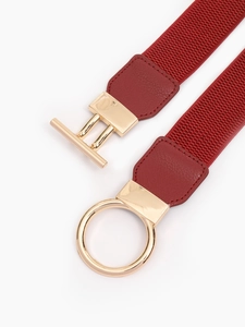 Close-up of red elastic belt with gold-tone buckle and lychee textured leather details