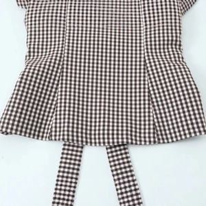 Brown and white checkered sleeveless top featuring adjustable hem drawstrings