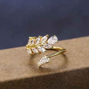 Macro shot of gold leaf ring with marquise-cut zircons and wheat ear detailing