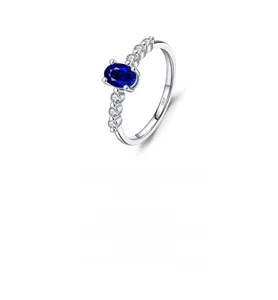 Detailed macro of S925 sterling silver ring with blue gemstone and side diamonds