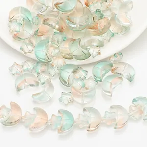 Detailed view of iridescent star and moon shaped glass beads for DIY jewelry making