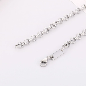 Macro detail of silver stainless steel chain with lobster clasp and blank square pendant