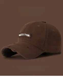 Close-up of distressed brim detail and Sunshine embroidery on brown washed cotton baseball cap