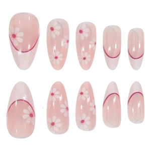 Almond shaped press-on nails featuring white daisies and pink accents on translucent base